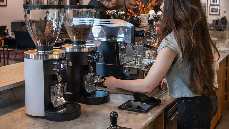 Mahlköng Grind-by-Sync grinders on cafe bar with barista